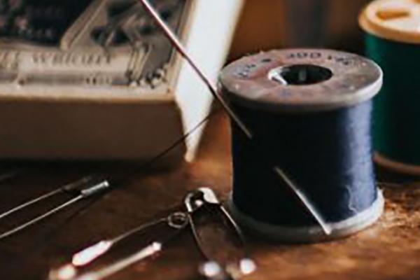 safety pins, sewing box and spool of black thread